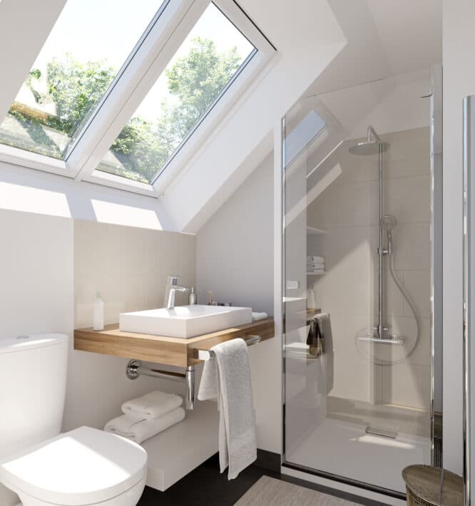 Salle de bains sous comble avec de grandes fenêtres de toit VELUX