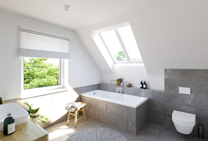 Salle de bains avec plafond incliné et fenêtre de toit VELUX, lumineuse et aérée.