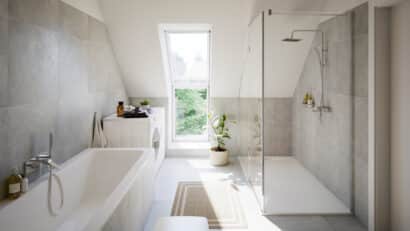 Salle de bain avec plafond en pente et fenêtre de toit VELUX, équipements modernes.