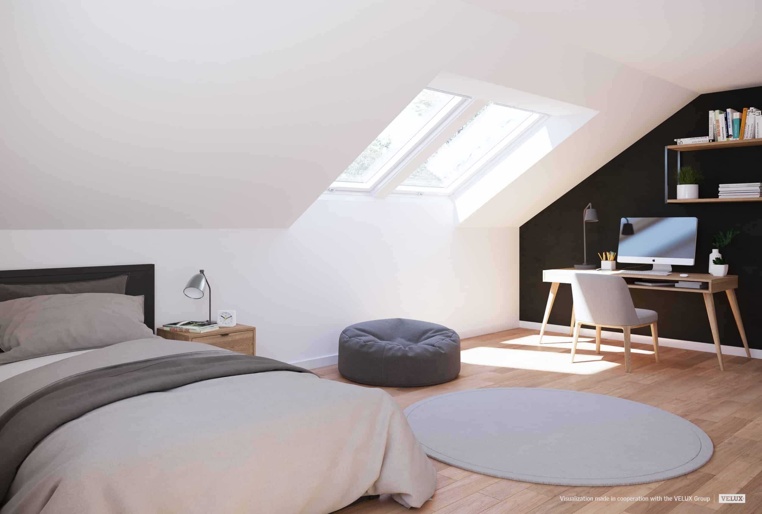 Chambre sous les combles avec plafond en pente et fen&ecirc;tre de toit VELUX laissant entrer la lumi&egrave;re naturelle.