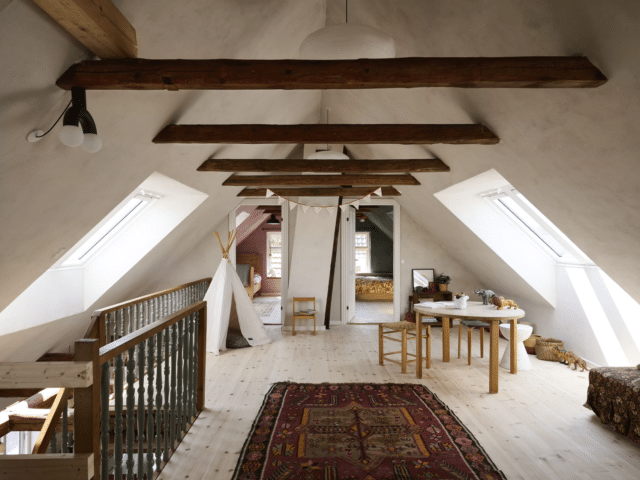 Palier de combles aménagés avec poutres apparentes.