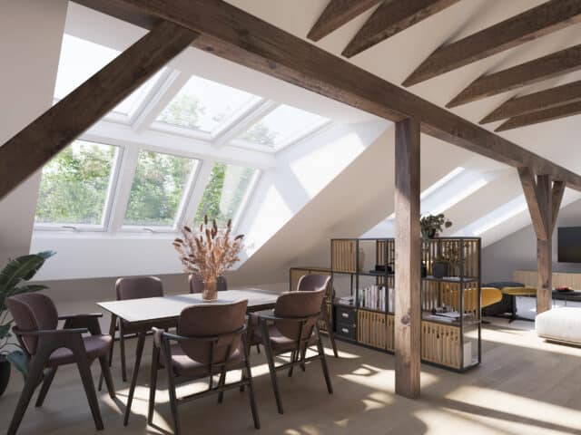Chambre mansardée avec fenêtres de toit VELUX et poutres apparentes.