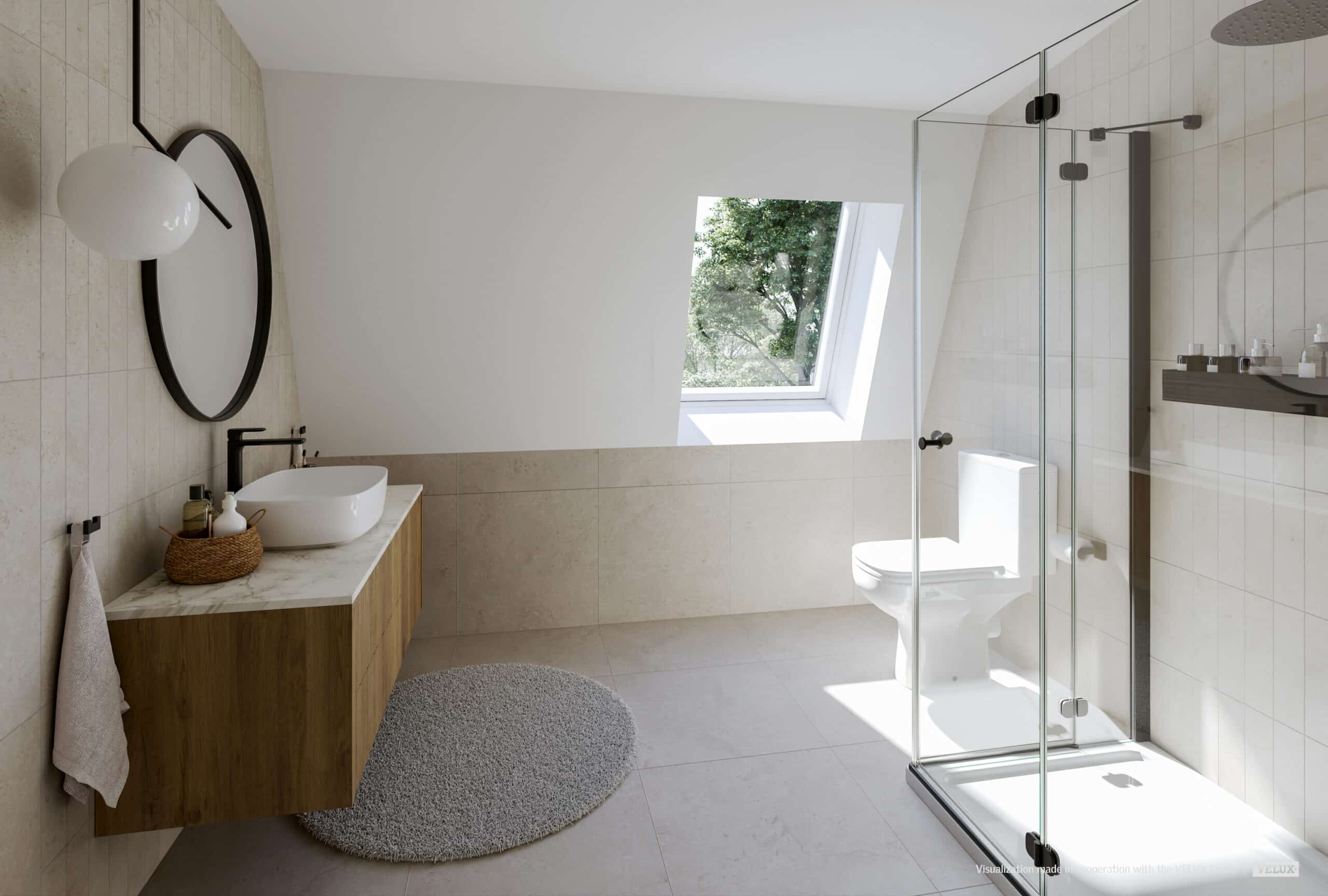 Salle de bains moderne, lumineuse et aérée, avec plafond en pente et fenêtre de toit VELUX.