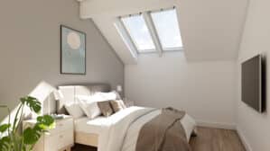 Chambre mansardée avec plafond incliné et fenêtres de toit VELUX, laissant entrer la lumière naturelle.