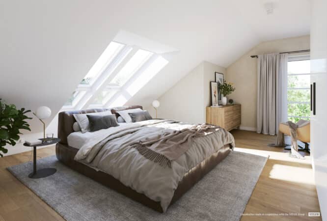 Chambre mansardée confortable avec plafond en pente et grandes fenêtres de toit VELUX laissant entrer la lumière naturelle.