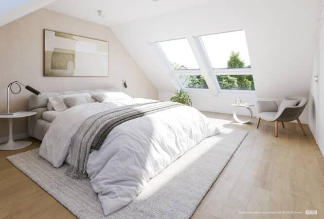 Chambre mansardée lumineuse avec plafond en pente et grandes fenêtres de toit VELUX laissant entrer la lumière naturelle.