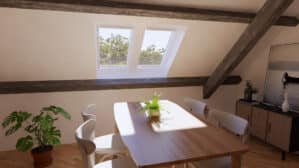 Coin repas sous les combles avec plafond en pente, charpente apparente et fenêtres de toit VELUX.