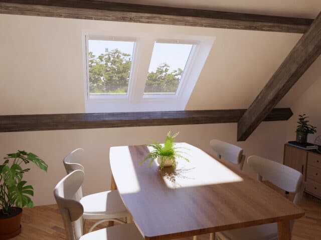 Coin repas sous les combles avec plafond en pente, charpente apparente et fenêtres de toit VELUX.