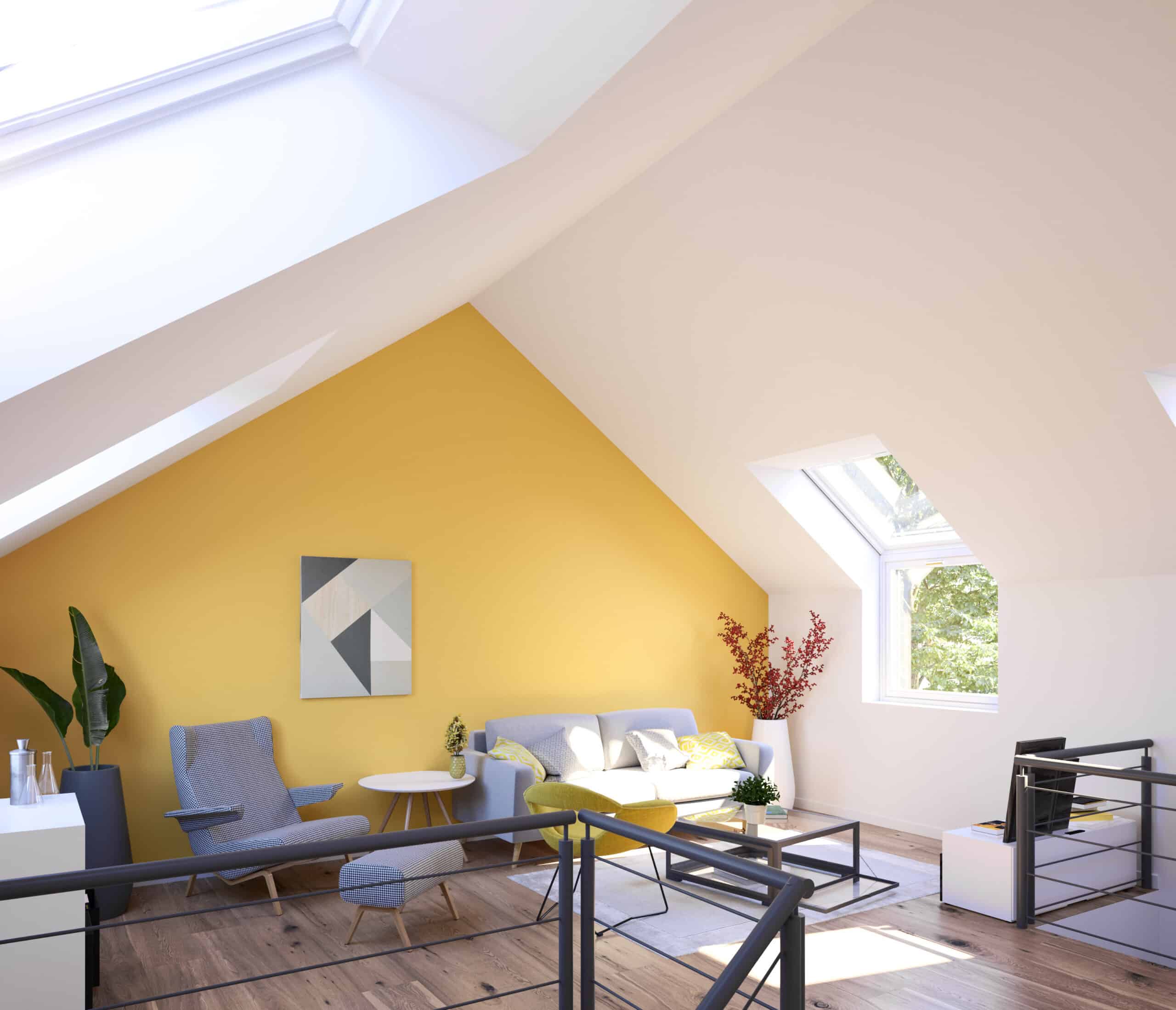 Pièce aménagée dans les combles, avec un plafond en pente, un mur jaune et des fenêtres de toit VELUX.